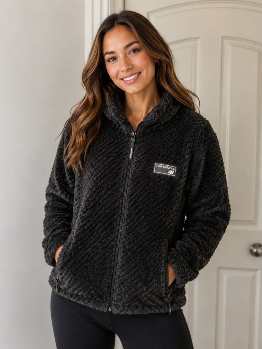 New Balance black fleece jacket features a full-zip closure